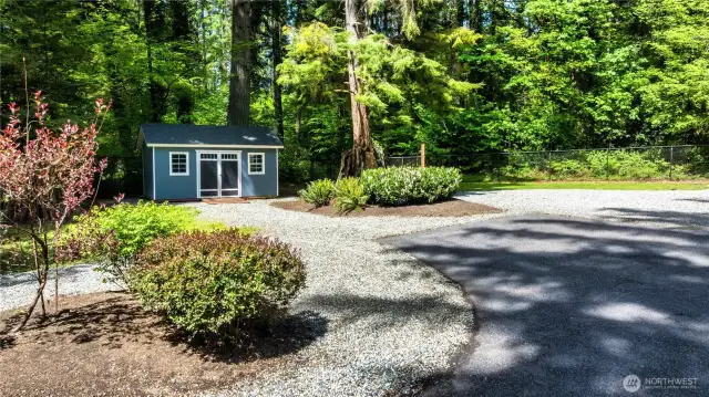 A custom shed provides convenient storage space.