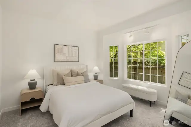 The spacious primary suite, located on the main floor, features a luxurious en-suite bath and a huge walk-in closet, offering comfort and convenience in one elegant retreat.