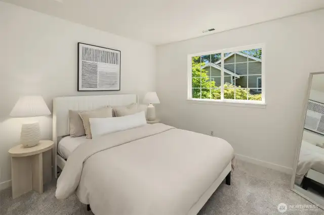 The upstairs secondary bedroom provides a comfortable and private space, ideal for guests, family, or a personalized retreat.