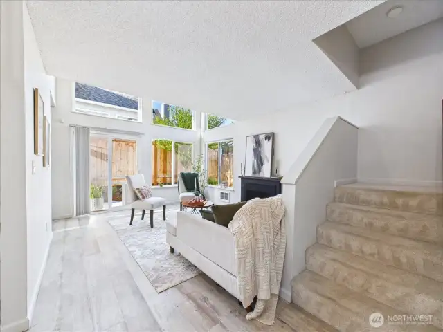 The natural light is flowing through the large windows and the vaulted ceiling in the living room gives this home an airy feel.