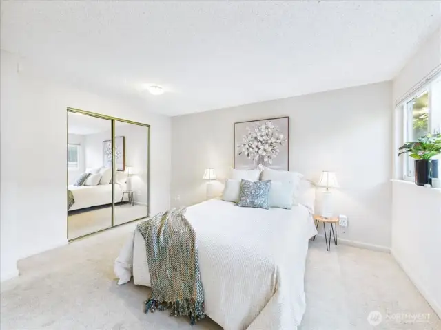 The mirrored closet doors give the illusion of the large room being even larger.
