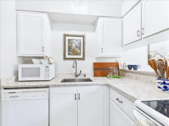 The beautiful compact white-on-white kitchen allows the cook a very efficient work flow.