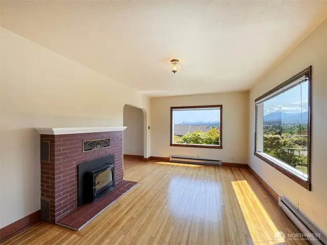 Greeted by Hardwood Floors & a Warm Fireplace Insert