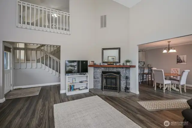 Living area with cathedral ceilings and wood burning fireplace for cozy evenings!