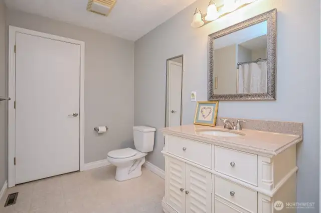 Guest bath has access to attic lighted storage area.