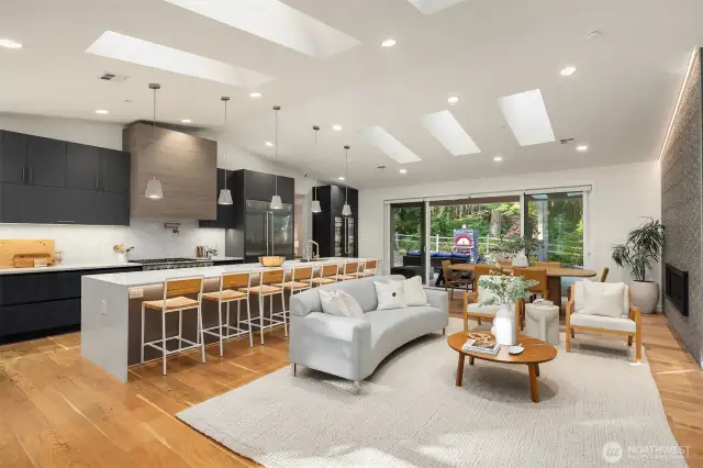 Complementing the custom luxury cabinetry are premium features including a wall-mounted Vent-A-Hood, pot filler, two sinks, glass rinser, filtered water, Ketra lighting, integrated storage drawers, and Brizo designer plumbing fixtures