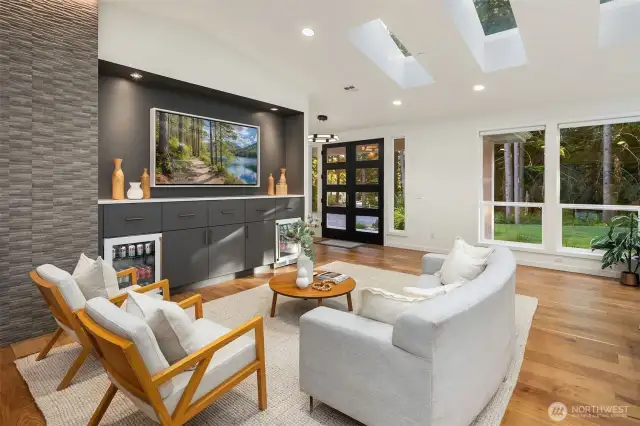 The great room showcases a stunning gas fireplace, dual built-in Perlick beverage centers, automated lighting with multiple functions, and fully integrated audio and motorized blinds.