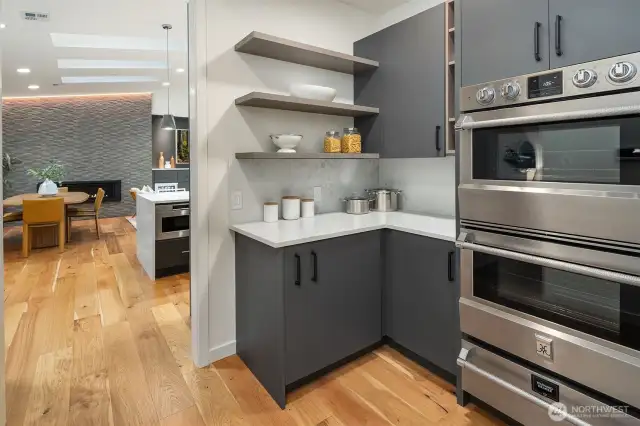 Enjoy the convenience of double ovens and a warming drawer in the fully outfitted butler’s pantry