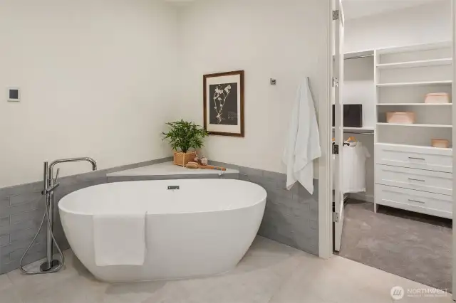 Indulge in the deep soaking tub located in the elegant primary bathroom