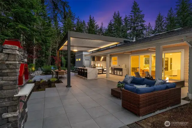 And now for the exterior! Enjoy the luxury of a show-stopping outdoor culinary space featuring a pizza oven and high-end appliances