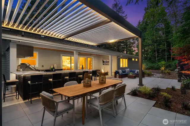 Step outside to an entertainer’s paradise with built-in heaters, surround sound, custom lighting, and a louvered roof equipped with rain sensors—perfect for extending your living and entertaining space