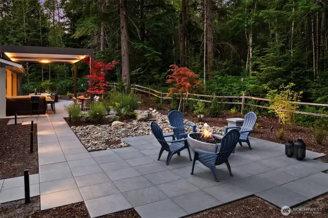The landscape, green space, and walkways are beautifully illuminated with Lumiere outdoor lighting, offering timer functions and full color control for effortless ambiance