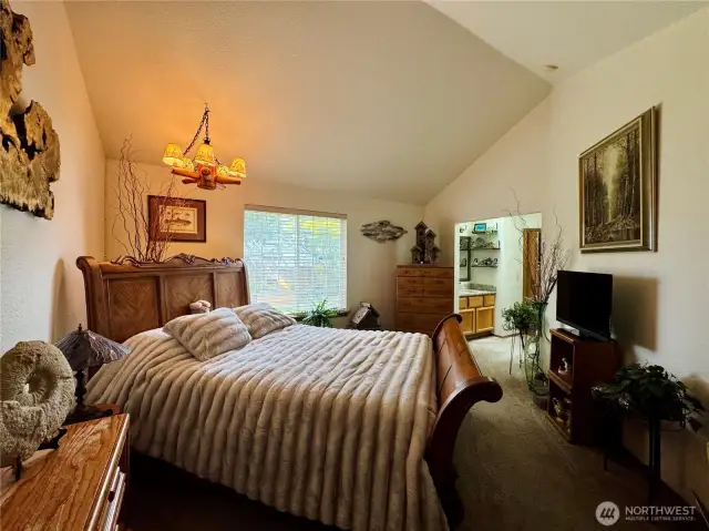 Very spacious vaulted primary bedroom with plenty of room for a king size bed.