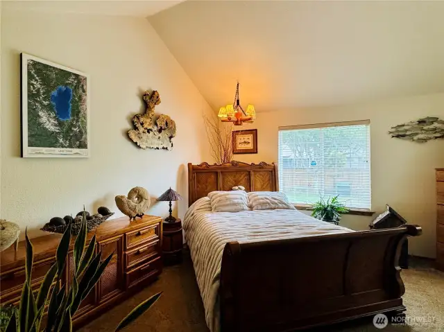 Very spacious vaulted primary bedroom with plenty of room for a king size bed.