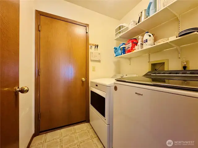 Laundry room off hallway with access to 2 car garage