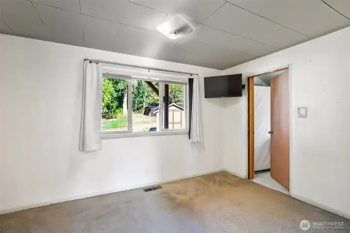 Primary bedroom with large window and en-suite