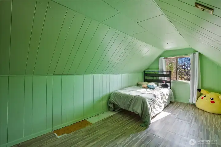 Whimsical upstairs bedroom with window and closet