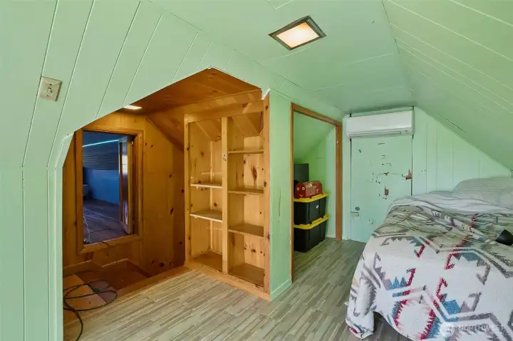 Whimsical upstairs bedroom with window and closet