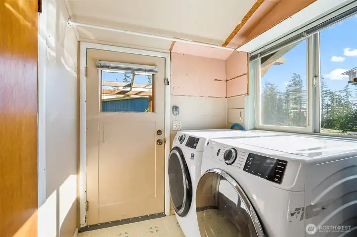 Light, bright laundry room with exterior door