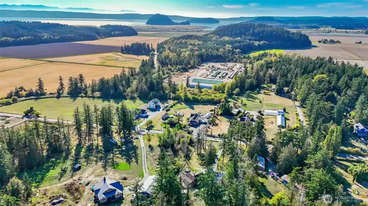 Aerial photo of property with large home, garage, sheds, ample space for RV parking, gardening, etc.