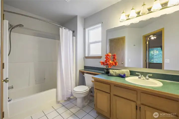 Primary full bath with tile floor