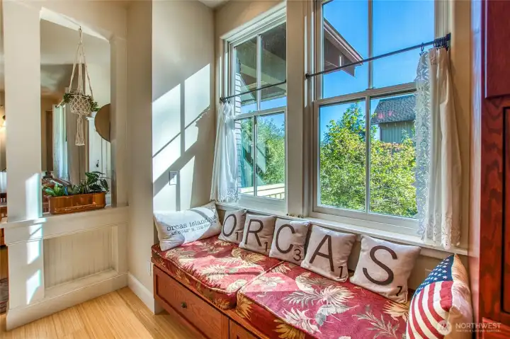 A window seat provides storage, southern light, and a place to lounge in the sun.
