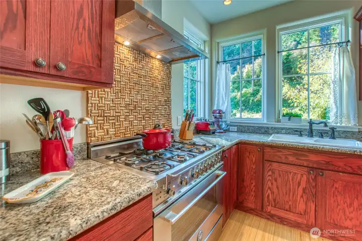 The Bertazzoni six burner propane range and hood add elegance and utility to the kitchen.