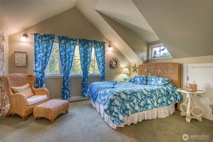 This bedroom has plenty of storage with two closets and extra storage in another closet under the eaves.