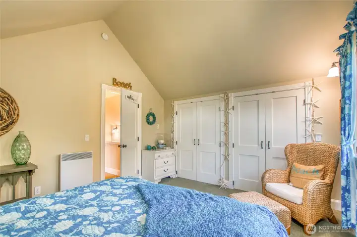 Vaulted ceilings and a dormer make the room feel airy comfortable.