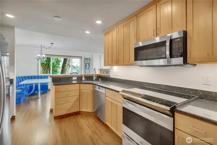 The fully equipped kitchen was upgraded in the recent past and features granite counters, plenty of cabinets with undercabinet lighting, and an open layout.