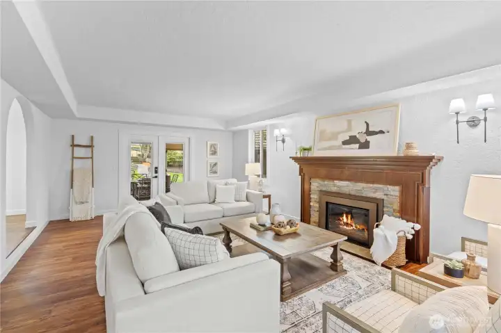 This formal living room is everything! classic fireplace, huge windows and serenity.  Outdoor living is just outside the door.
