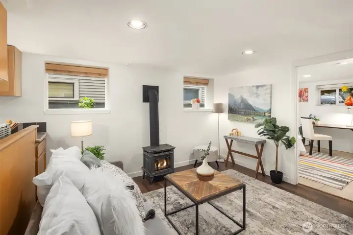 Lower level open floor living room with classic gas stove