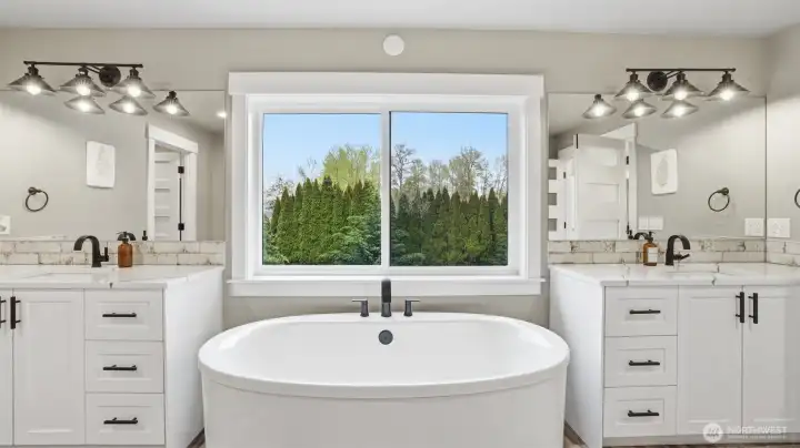 Large soaker tub with backyard views!