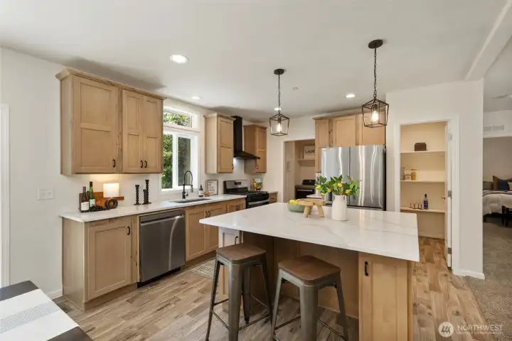 Kitchen with SS appliances, walk in pantry and laundry through the doorway to the left of the fridge.
