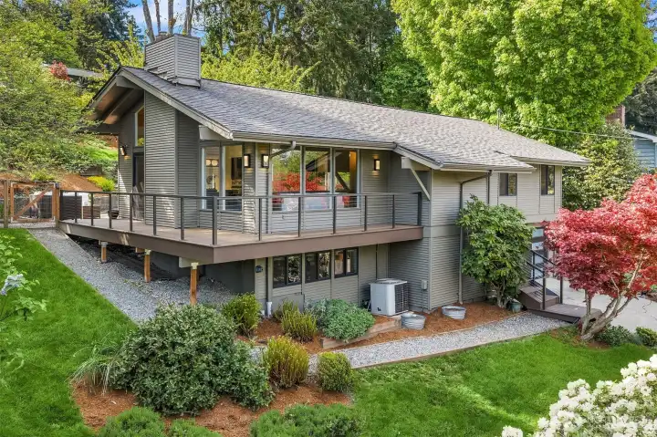 Set on an 11,824 sq ft lot, this property features wonderful indoor and outdoor spaces. Step out to the wraparound composite deck overlooking beautiful mature landscaping.
