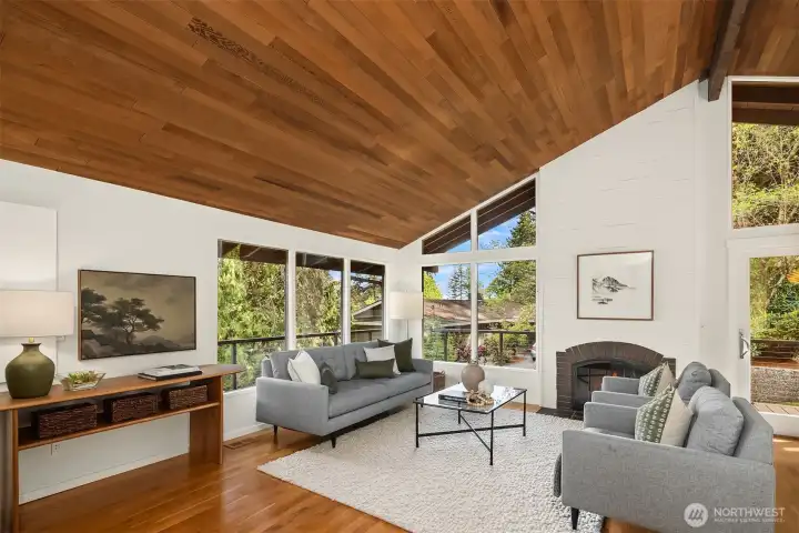 Step inside and discover striking modern design with floor-to-ceiling windows, beautiful hardwoods, and vaulted natural wood ceilings.