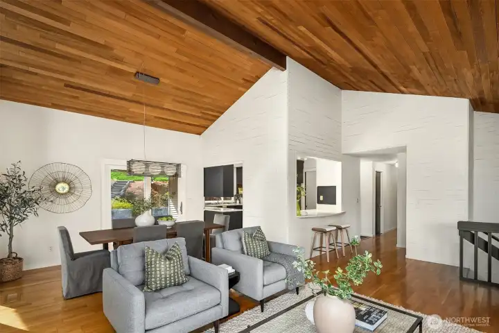 Perspective of living room looking toward dining room and kitchen – hallway leads to three bedrooms.
