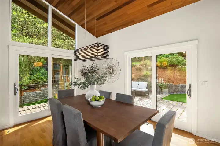 Bright, open-concept spaces flow seamlessly outdoors – French sliders from the dining room open to the wraparound deck and sunny back patio for effortless entertaining.