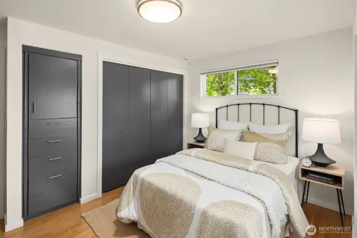 Perspective of second spacious bedroom on the main floor featuring wonderful built-in storage and closet space.