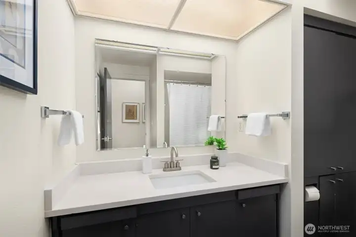 Full bathroom with beautiful quartz countertop near bedrooms on the main floor.