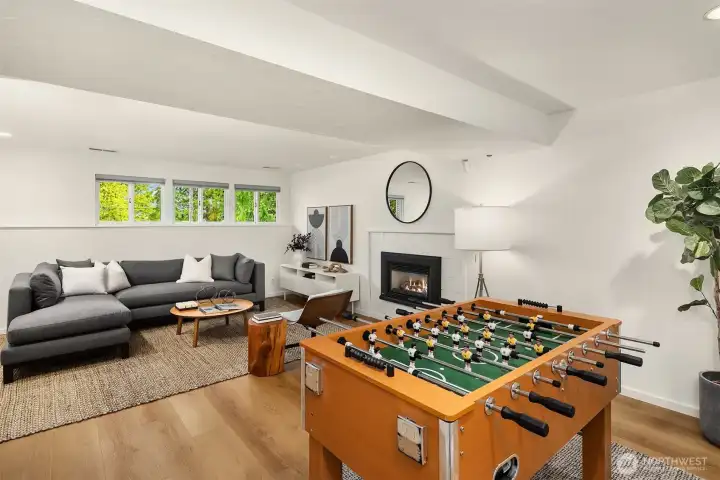Large family room with gas fireplace – newer luxury plank vinyl flooring throughout lower level.