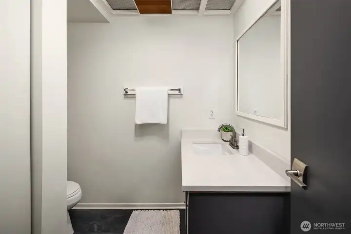 Half-bath on the lower level, plumbed for a shower