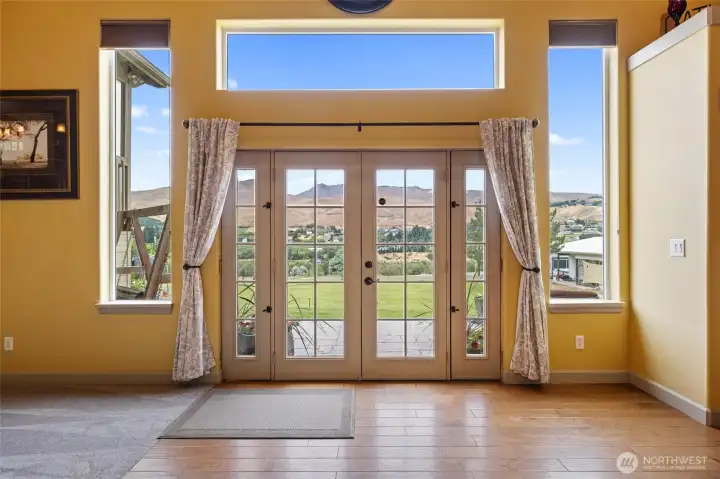 Interior Entry - French doors and opening sidelights creates a seamless connection to the outdoor living spaces while capturing panoramic views