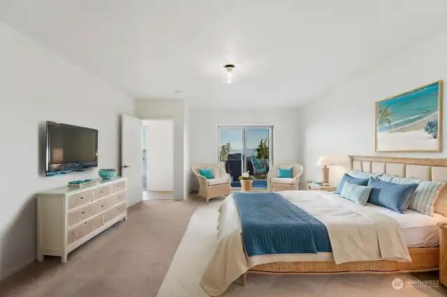 Virtually Staged. Spacious Primary bedroom with deck access, walk-in closet and ensuite.