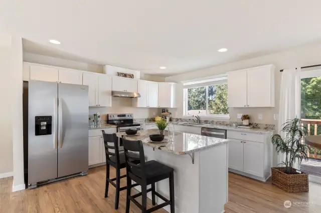 Beautiful kitchen to prepare gourmet meals boasts stainless steel appliances and gorgeous quartz counters with practical island and plenty of cabinet space!