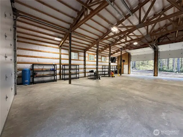 30 and 50 amp power in the garage.  Full hookups for trailer or RV. There are power outlets up high in hte corners of the garage for indoor security cameras or more garage heaters. Garage racks stay with the garage.