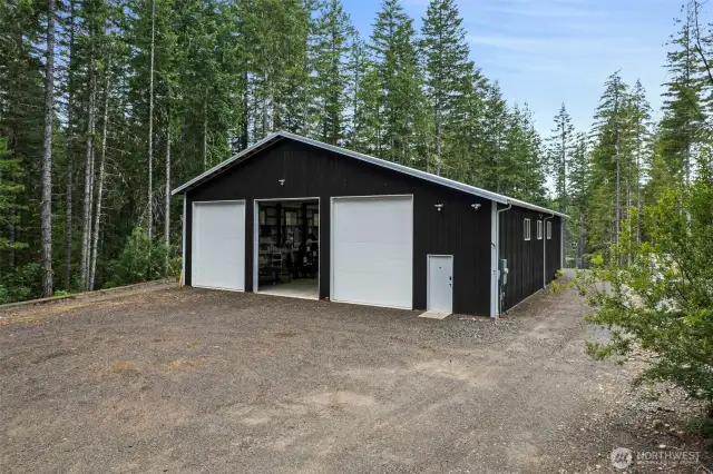 The driveway starts at the street, NE Tee Lake Road, and goes the full length of the property down to the home building site.  The driveway is fully graveled.