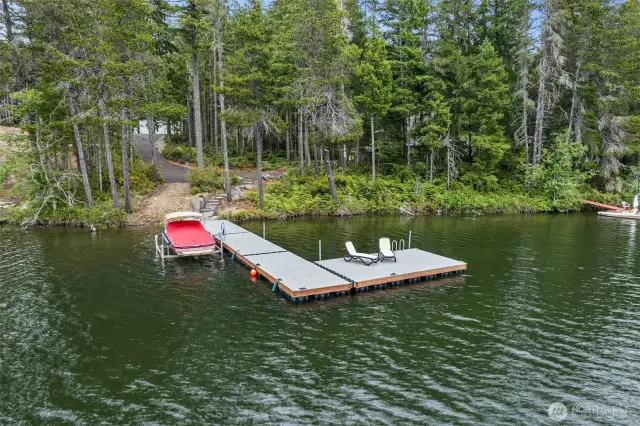 This is a view of  the property from the lake looking up to the garage.  The designated home building site is the first open space as you walk up from the dock.