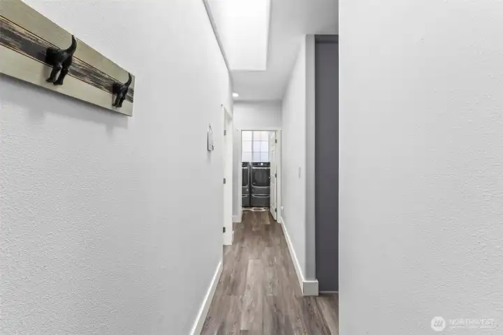 Hallway towards utility room and primary ensuite and hallway bathroom