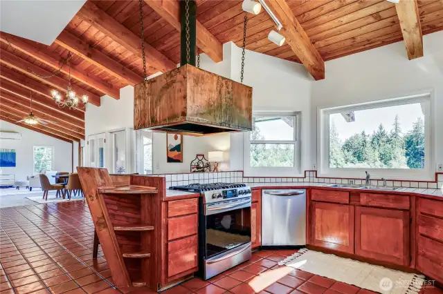 Kitchen with large copper hood - brand new propane range